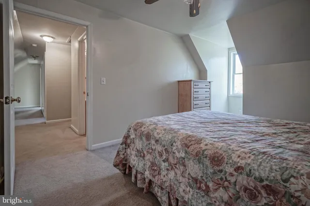 a bed sitting in a room next to a lamp