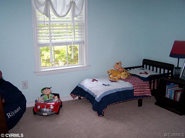 1852 Taylor Road Crozier, VA 23039 - Photo 8 of 12 a bedroom with a bed and a window