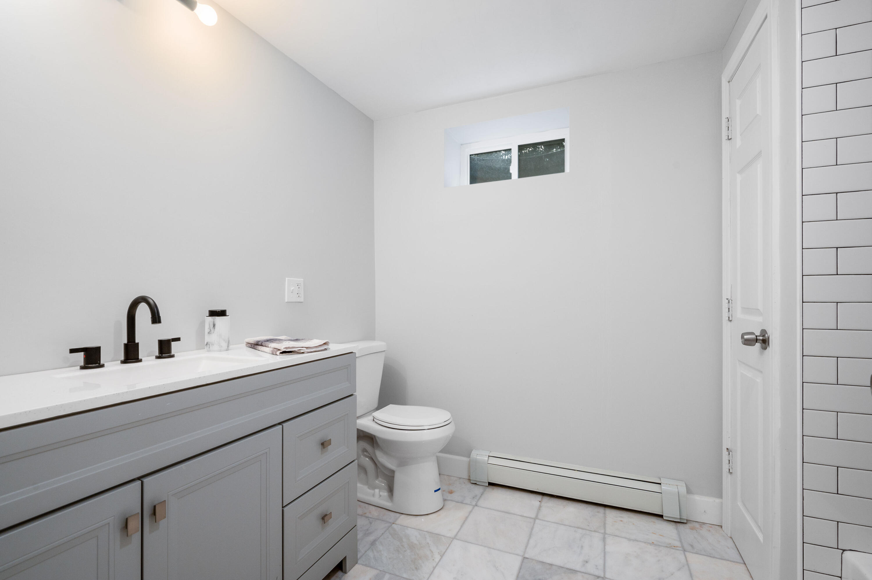 9 Tarragon Circle Cotuit, MA 02635 - Photo 17 of 28 a bathroom with a toilet a sink and mirror