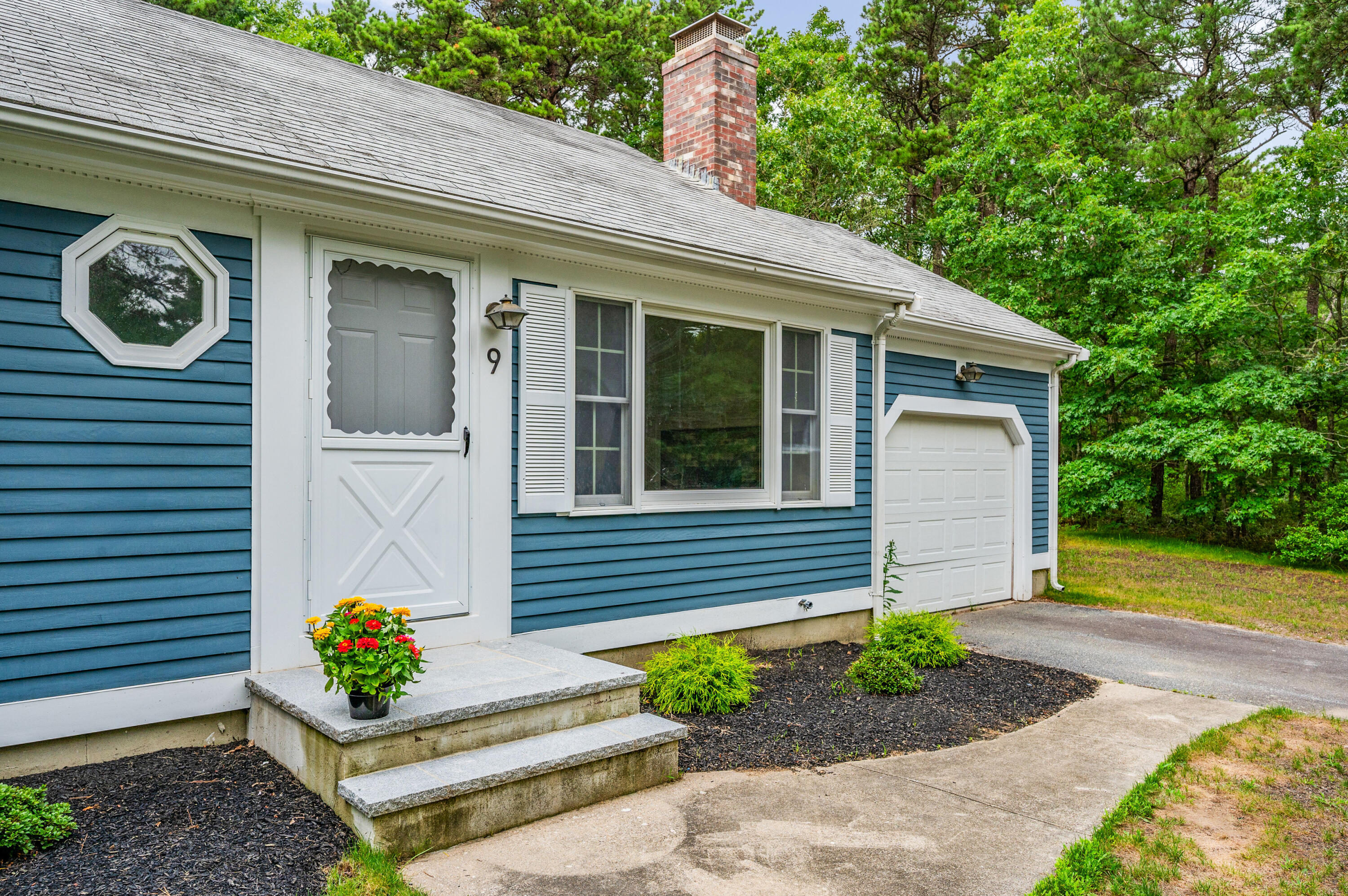 9 Tarragon Circle Cotuit, MA 02635 - Photo 2 of 28 a front view of a house with garden