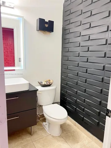 a room with lots of books and chairs