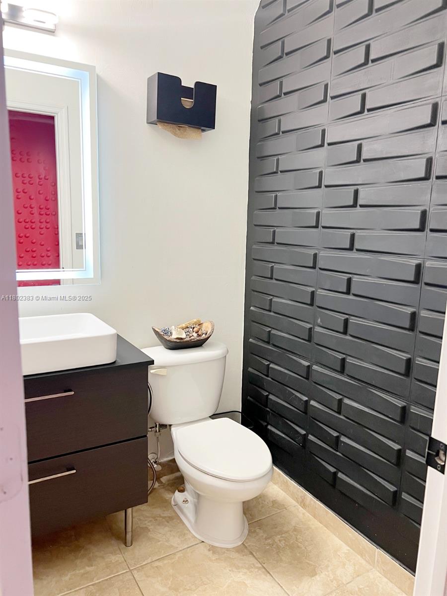 20124 Southwest 129th Place, Unit 20124 Miami, FL 33177 - Photo 12 of 31 a bathroom with a toilet and a sink