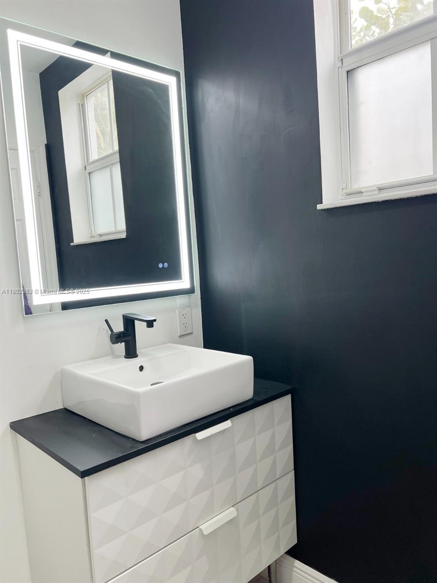 20124 Southwest 129th Place, Unit 20124 Miami, FL 33177 - Photo 15 of 31 a bathroom with a sink vanity and mirror