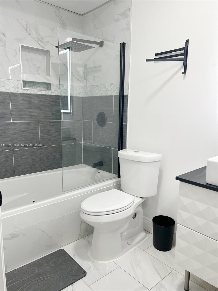 20124 Southwest 129th Place, Unit 20124 Miami, FL 33177 - Photo 16 of 31 a bathroom with a toilet and a shower