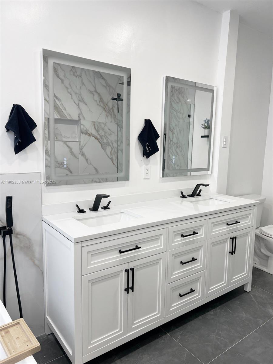 20124 Southwest 129th Place, Unit 20124 Miami, FL 33177 - Photo 20 of 31 a bathroom with a sink and a mirror