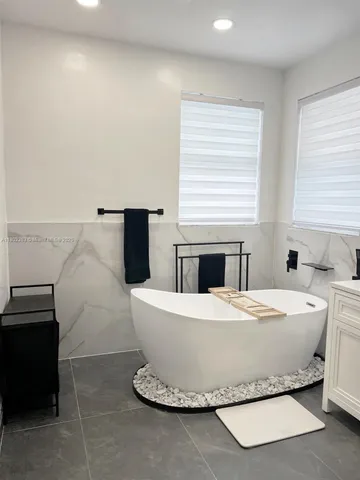 a bathroom with a double vanity sink and mirror