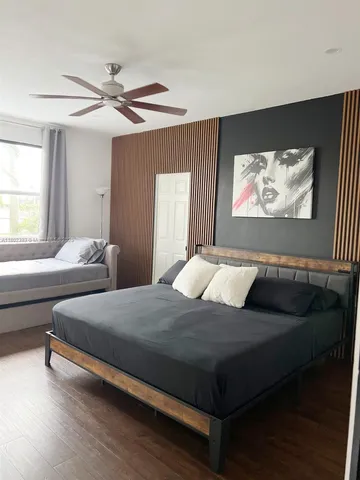 a bedroom with two beds and a large window