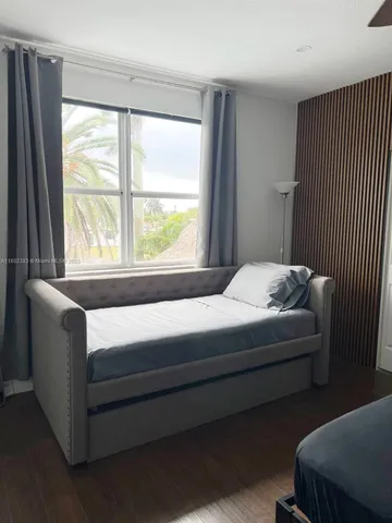 a bedroom with a bed and wall painting