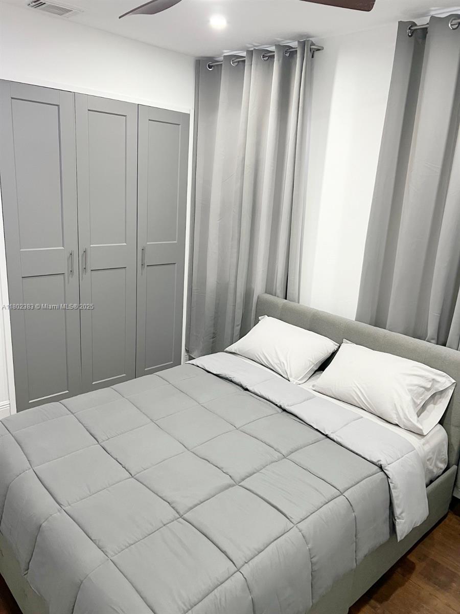 20124 Southwest 129th Place, Unit 20124 Miami, FL 33177 - Photo 29 of 31 a bedroom with a bed and a window