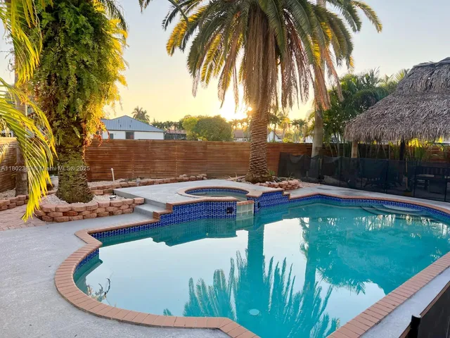 a view of swimming pool with a patio and a garden