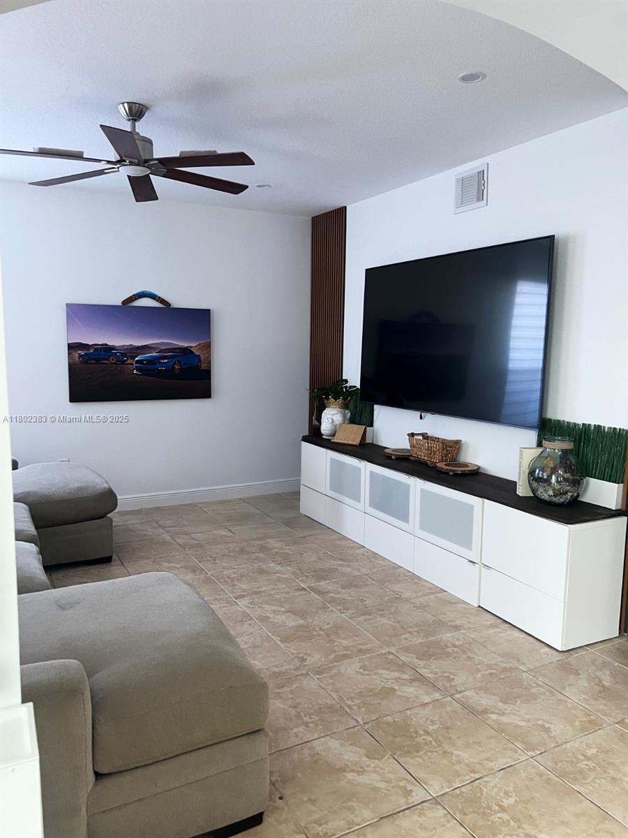 20124 Southwest 129th Place, Unit 20124 Miami, FL 33177 - Photo 8 of 31 a living room with furniture and a flat screen tv