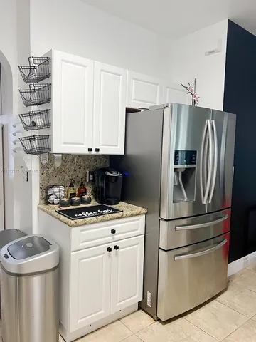 a kitchen with granite countertop a sink a stove and a microwave
