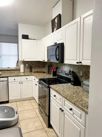 a bathroom with a sink vanity mirror and toilet