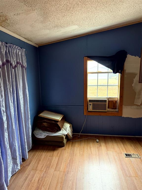 1047 John Wayne Road Kaufman, TX 75142 - Photo 10 of 17 Unfurnished bedroom featuring hardwood / wood-style flooring, a textured ceiling, and vaulted ceiling