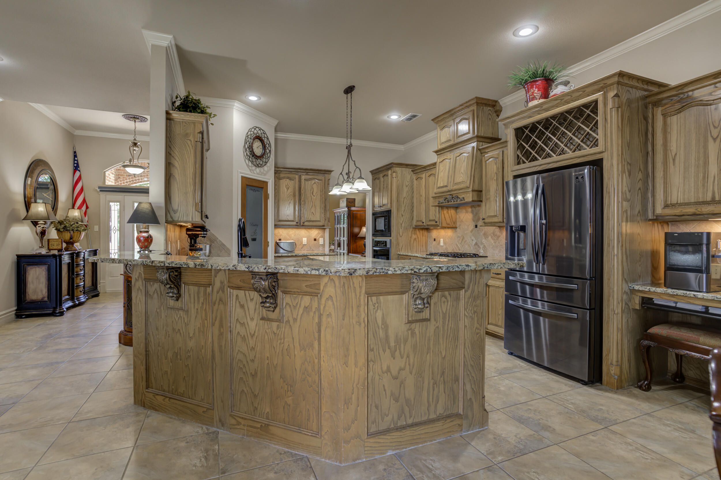 6008 89th Street Lubbock, TX 79424 - Photo 16 of 61 a kitchen with kitchen island a counter top stainless steel appliances and cabinets