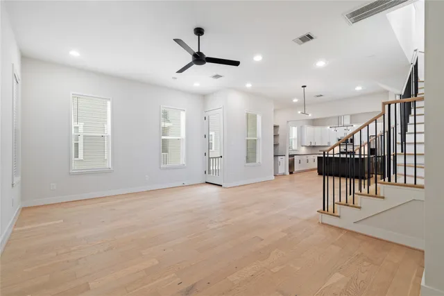 an empty room with a projector and windows