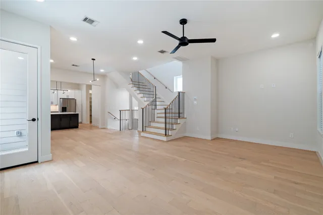 a view of an empty room with a kitchen