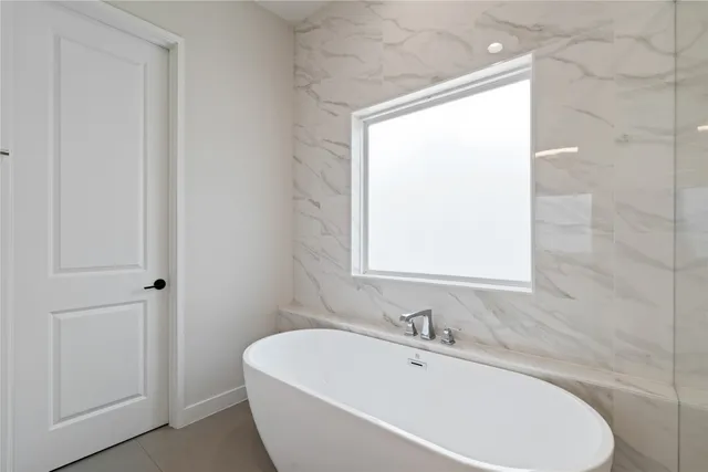 a white bath tub sitting next to a white sink