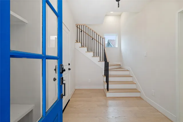 a view of entryway and hall with wooden floor