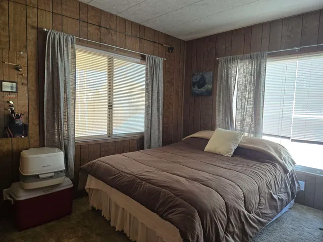 a bedroom with a bed and a chair