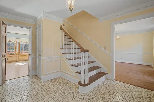 a big room with wooden floor and windows