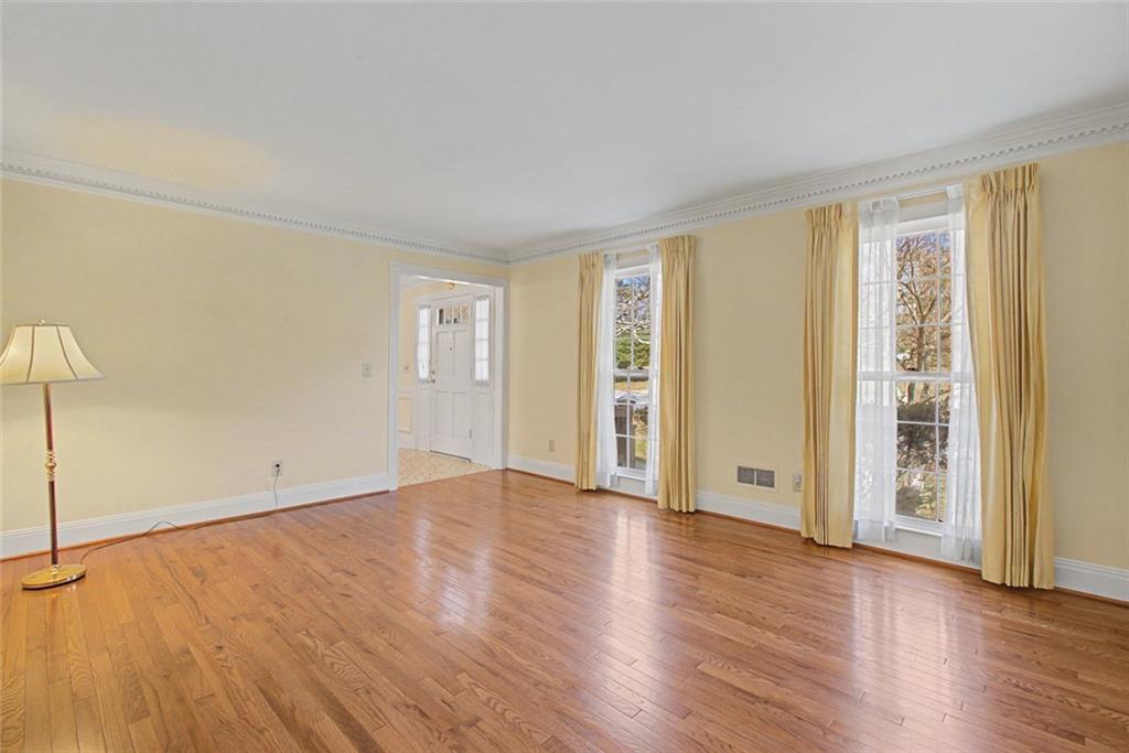 5877 Millstone Run Stone Mountain, GA 30087 - Photo 12 of 71 a view of an empty room with wooden floor and a window