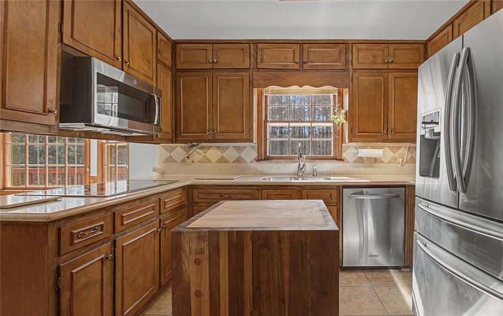 5877 Millstone Run Stone Mountain, GA 30087 - Photo 22 of 71 a kitchen with stainless steel appliances granite countertop a refrigerator and a sink