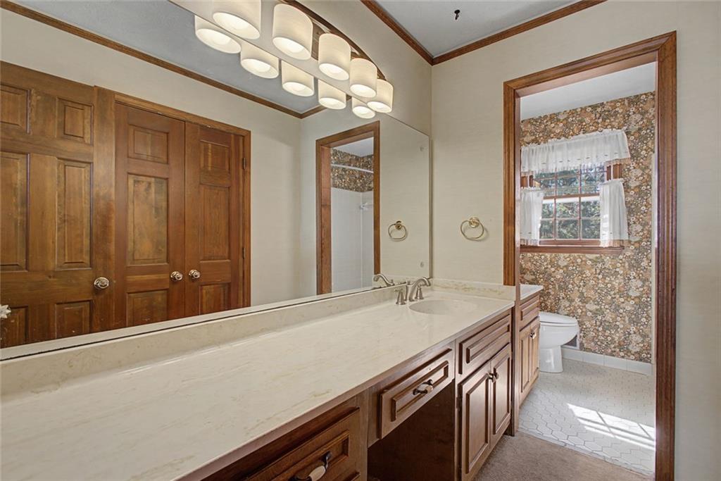 5877 Millstone Run Stone Mountain, GA 30087 - Photo 27 of 71 a bathroom with a sink a vanity and a large mirror