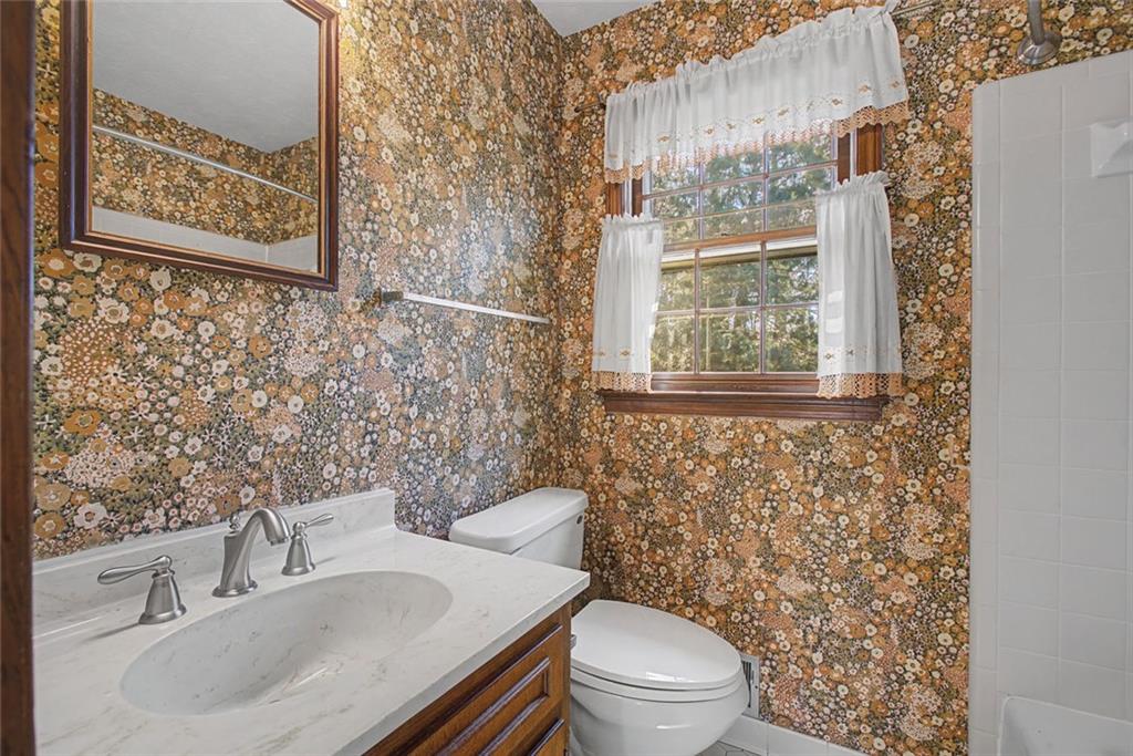 5877 Millstone Run Stone Mountain, GA 30087 - Photo 28 of 71 a bathroom with a sink a toilet and a mirror