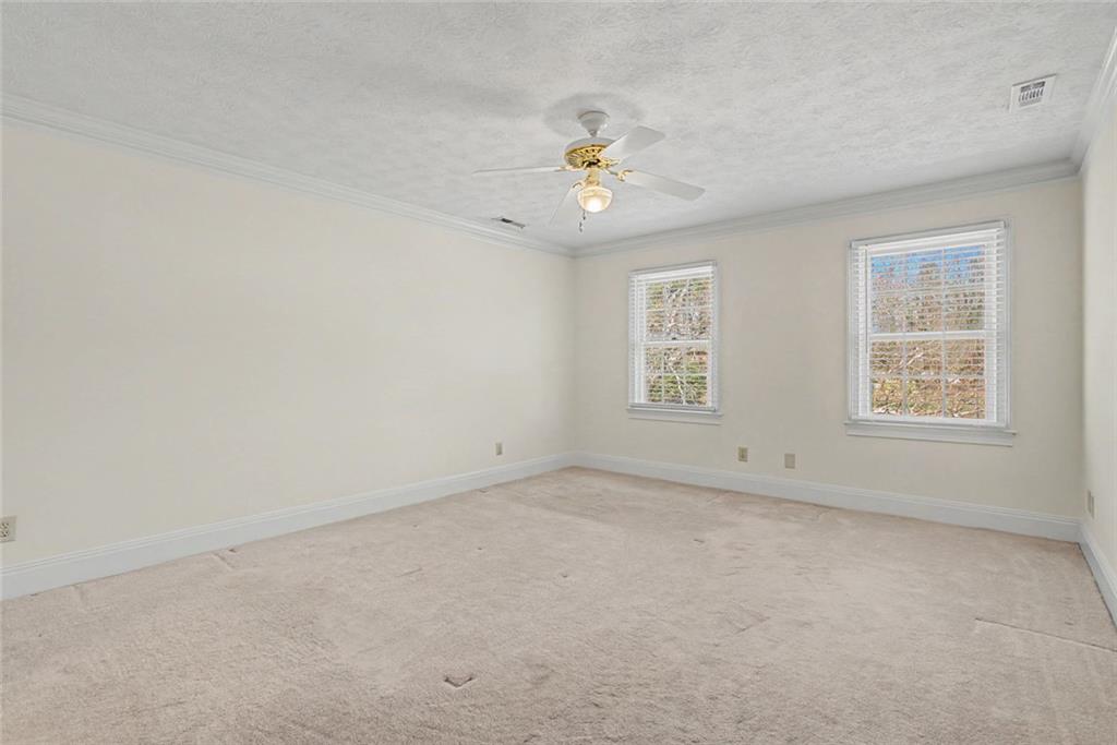 5877 Millstone Run Stone Mountain, GA 30087 - Photo 30 of 71 an empty room with a window and a fan