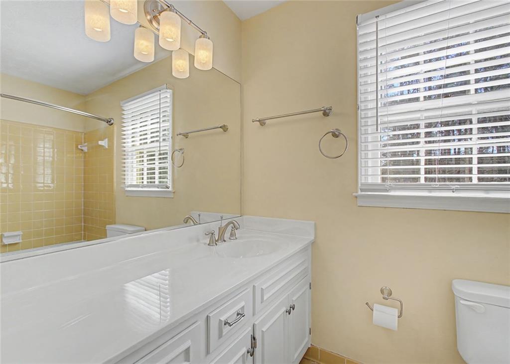 5877 Millstone Run Stone Mountain, GA 30087 - Photo 36 of 71 a bathroom with a sink a toilet and a window
