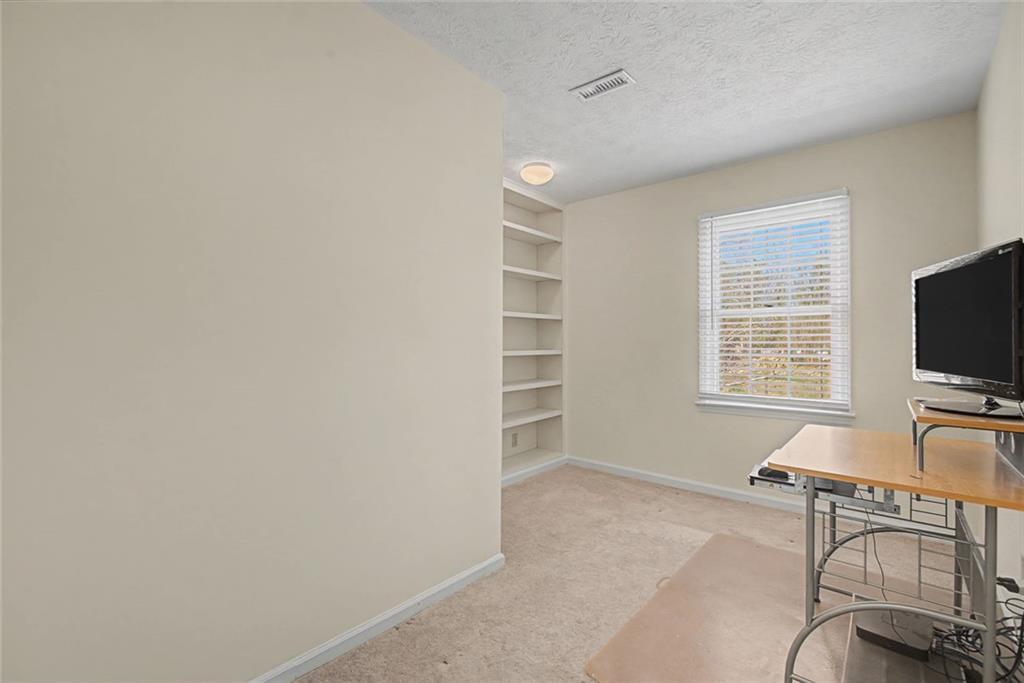 5877 Millstone Run Stone Mountain, GA 30087 - Photo 39 of 71 a living room with furniture and a flat screen tv