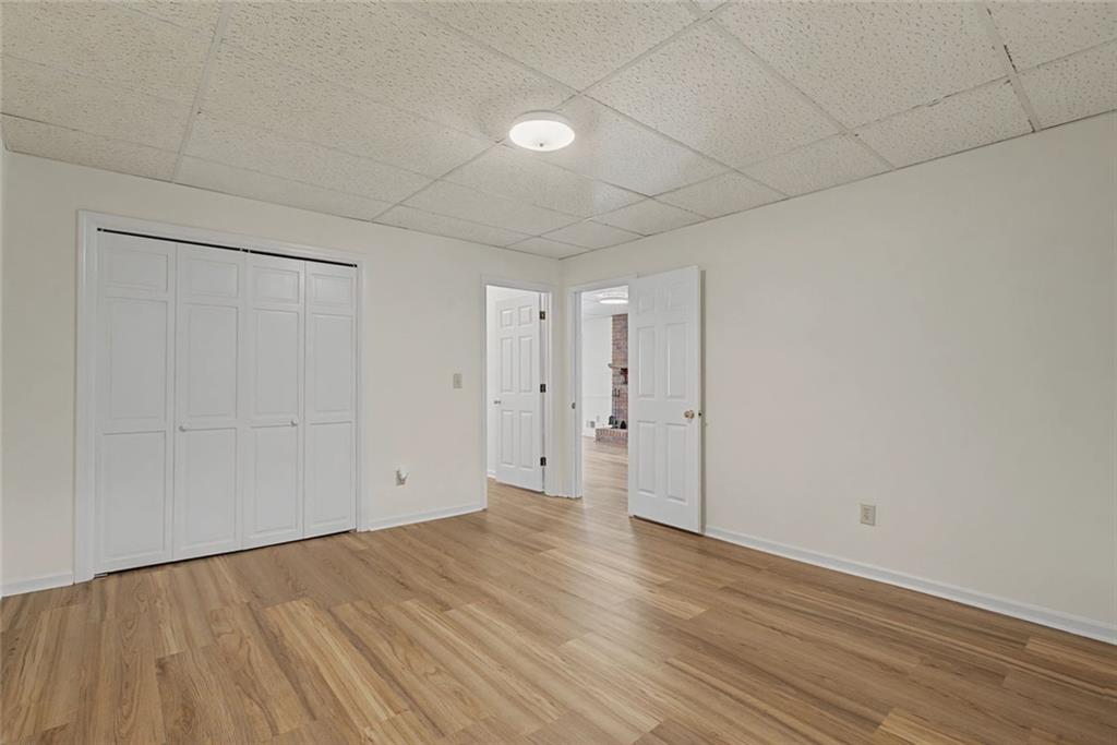 5877 Millstone Run Stone Mountain, GA 30087 - Photo 46 of 71 a view of an empty room with wooden floor