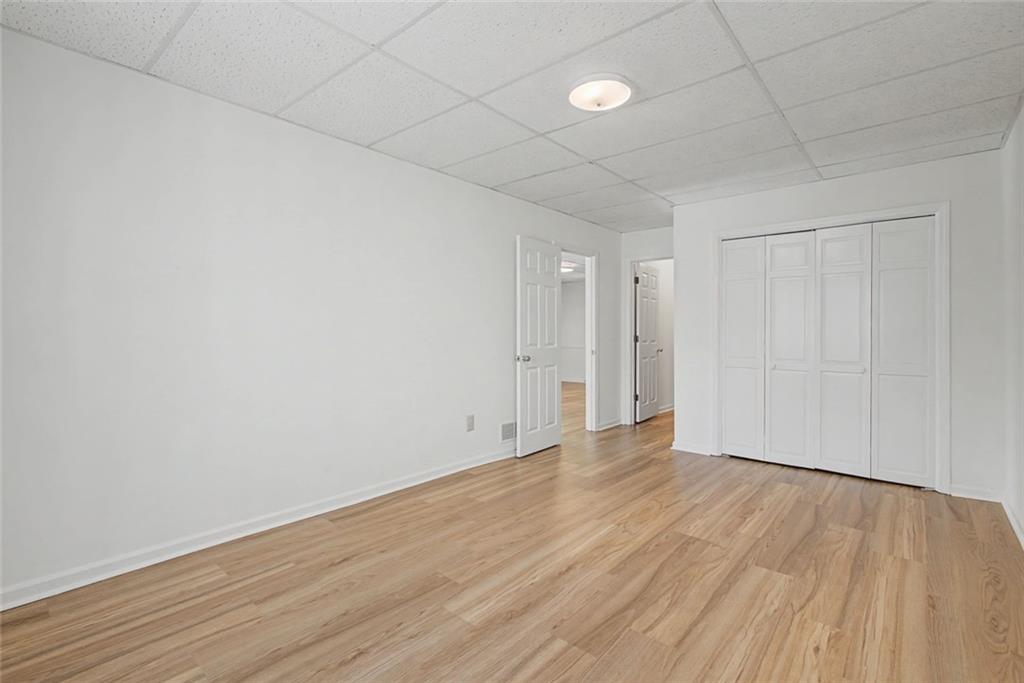 5877 Millstone Run Stone Mountain, GA 30087 - Photo 48 of 71 a view of an empty room with wooden floor