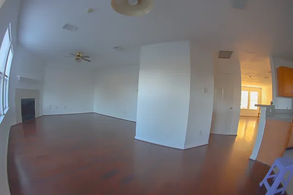 a view of an empty room with a fireplace and a window