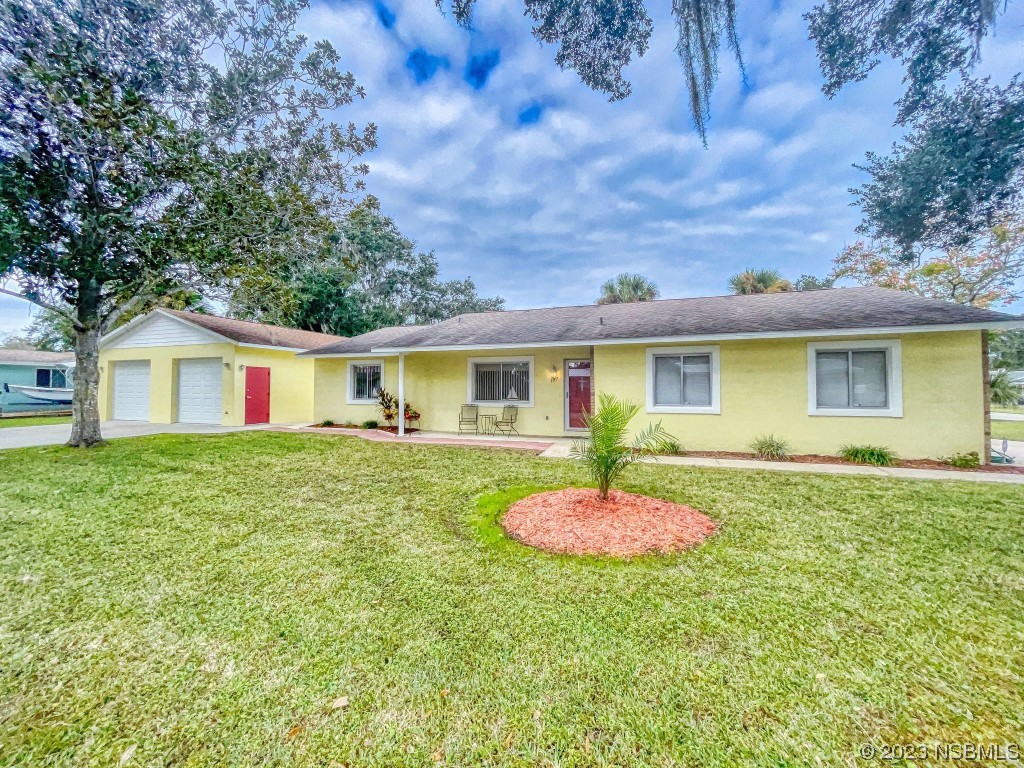 a front view of house with yard and trees