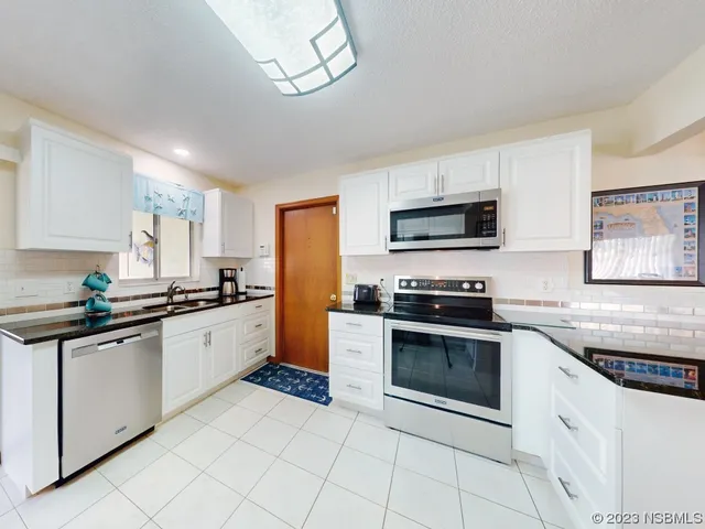 a living room with chairs and a table