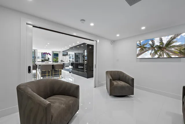 a living room with furniture and a large mirror