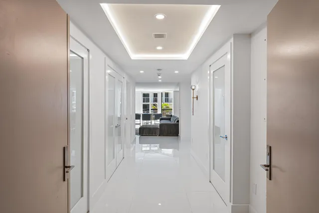 a living room with furniture and a view of bedroom