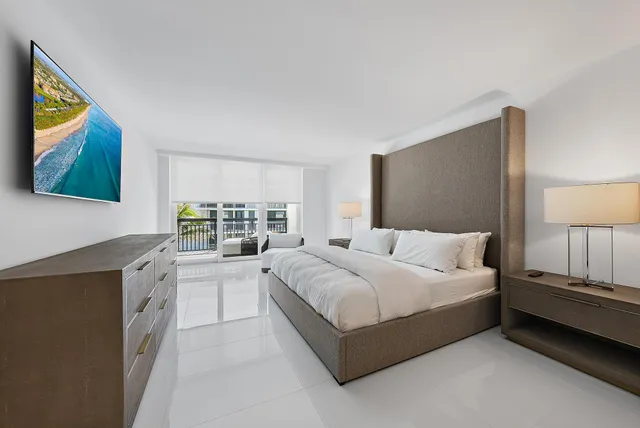 a spacious bedroom with a large bed and a window