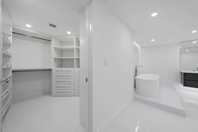 view of an empty room and a bathroom