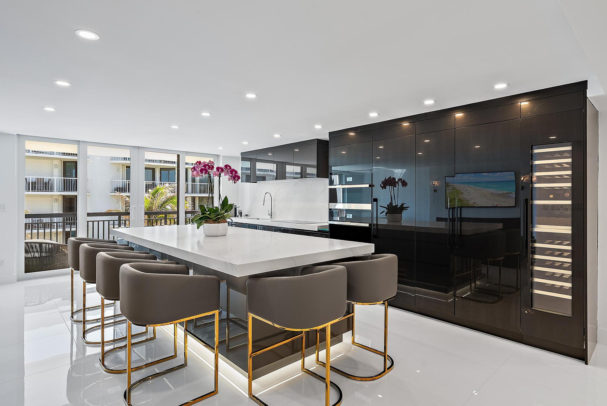 3140 South Ocean Boulevard, Unit 502S Palm Beach, FL 33480 - Photo 3 of 30 a kitchen with stainless steel appliances kitchen island granite countertop a sink and cabinets