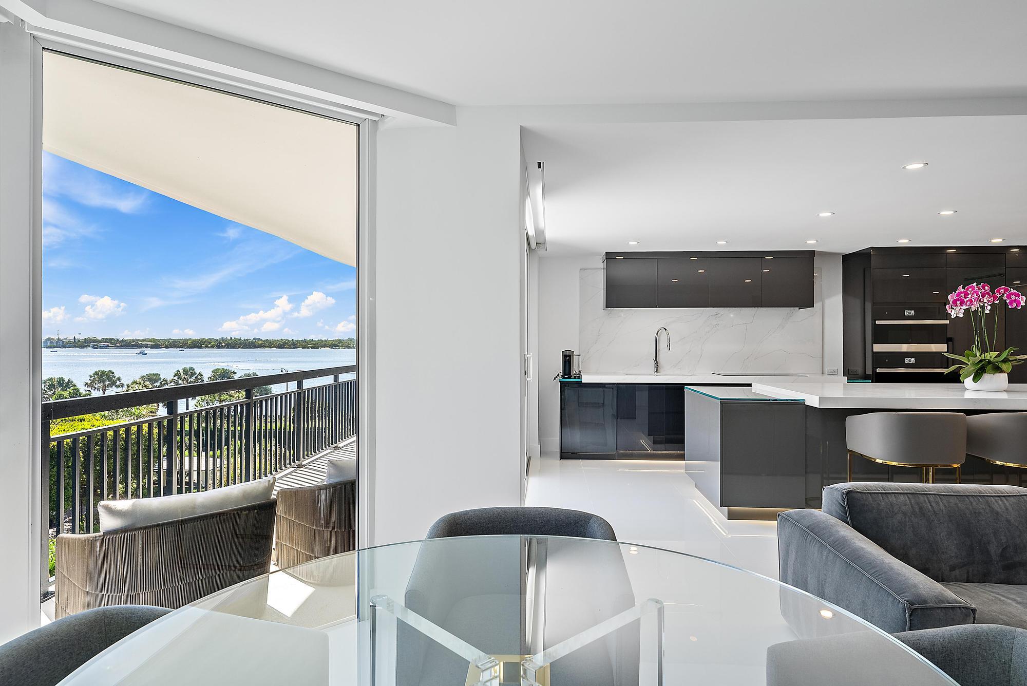 3140 South Ocean Boulevard, Unit 502S Palm Beach, FL 33480 - Photo 4 of 30 a living room with a couch and a flat screen tv