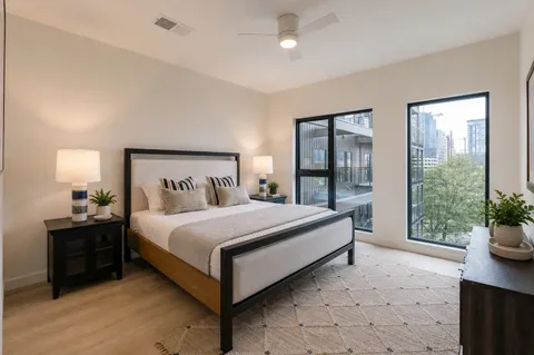 a spacious bedroom with two beds and a lamp