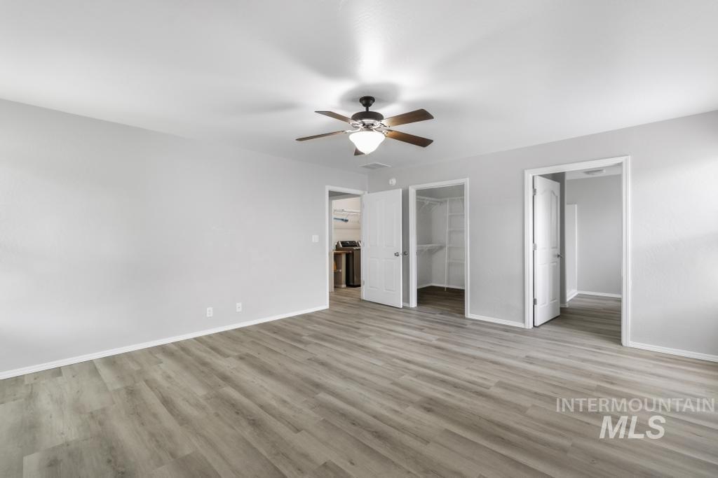 1183 Cortes Loop Twin Falls, ID 83301 - Photo 18 of 30 Spacious room featuring wood-finish flooring, light grey walls, and a ceiling fan with integrated lighting