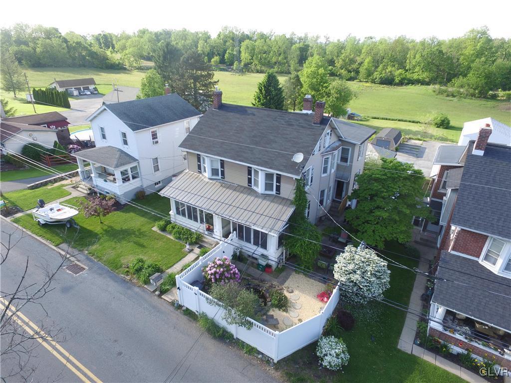 an aerial view of a house with garden space and street view