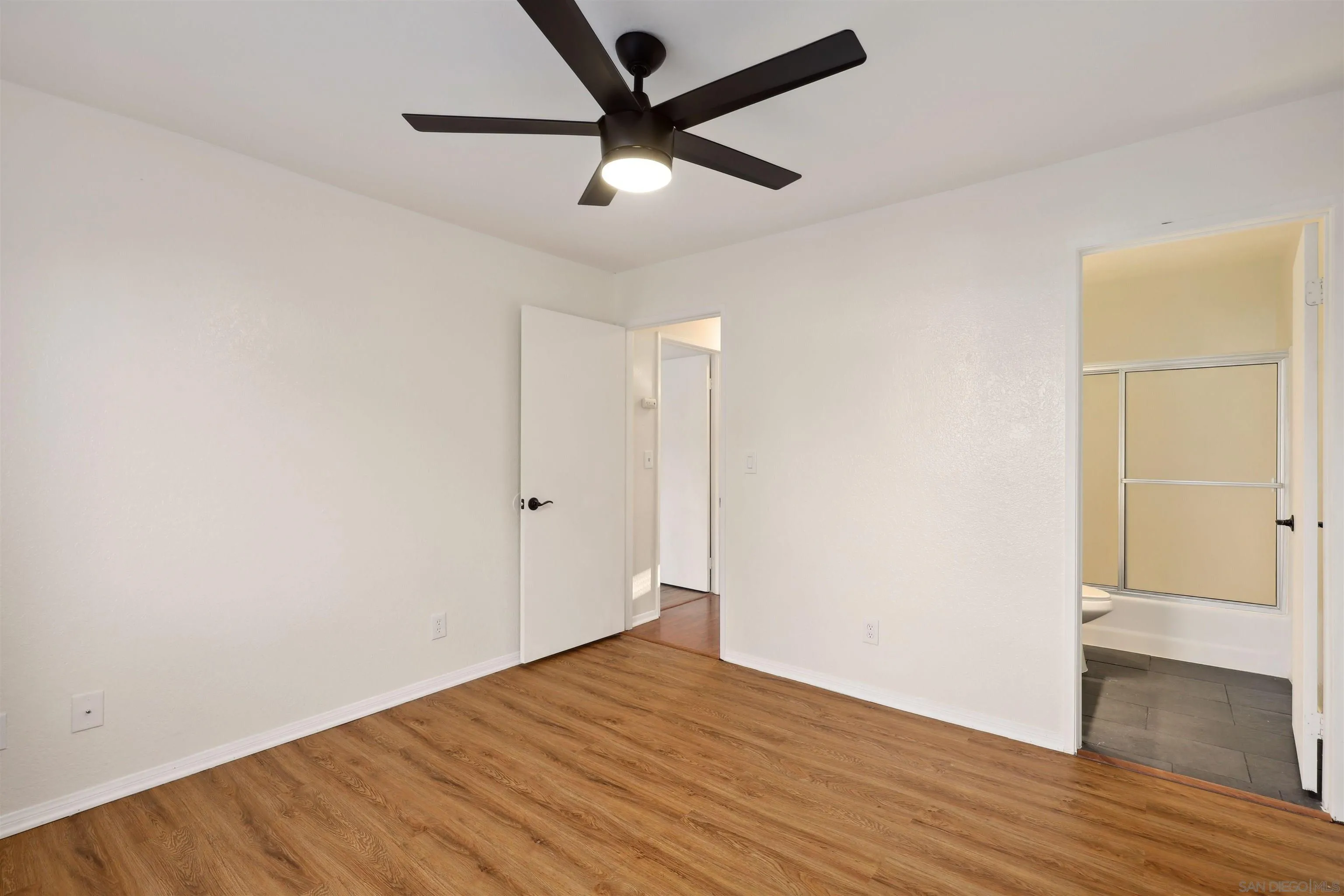 8475 Avenida Angulia, Unit 4 Spring Valley, CA 91977 - Photo 17 of 25 an empty room with wooden floor and a ceiling fan