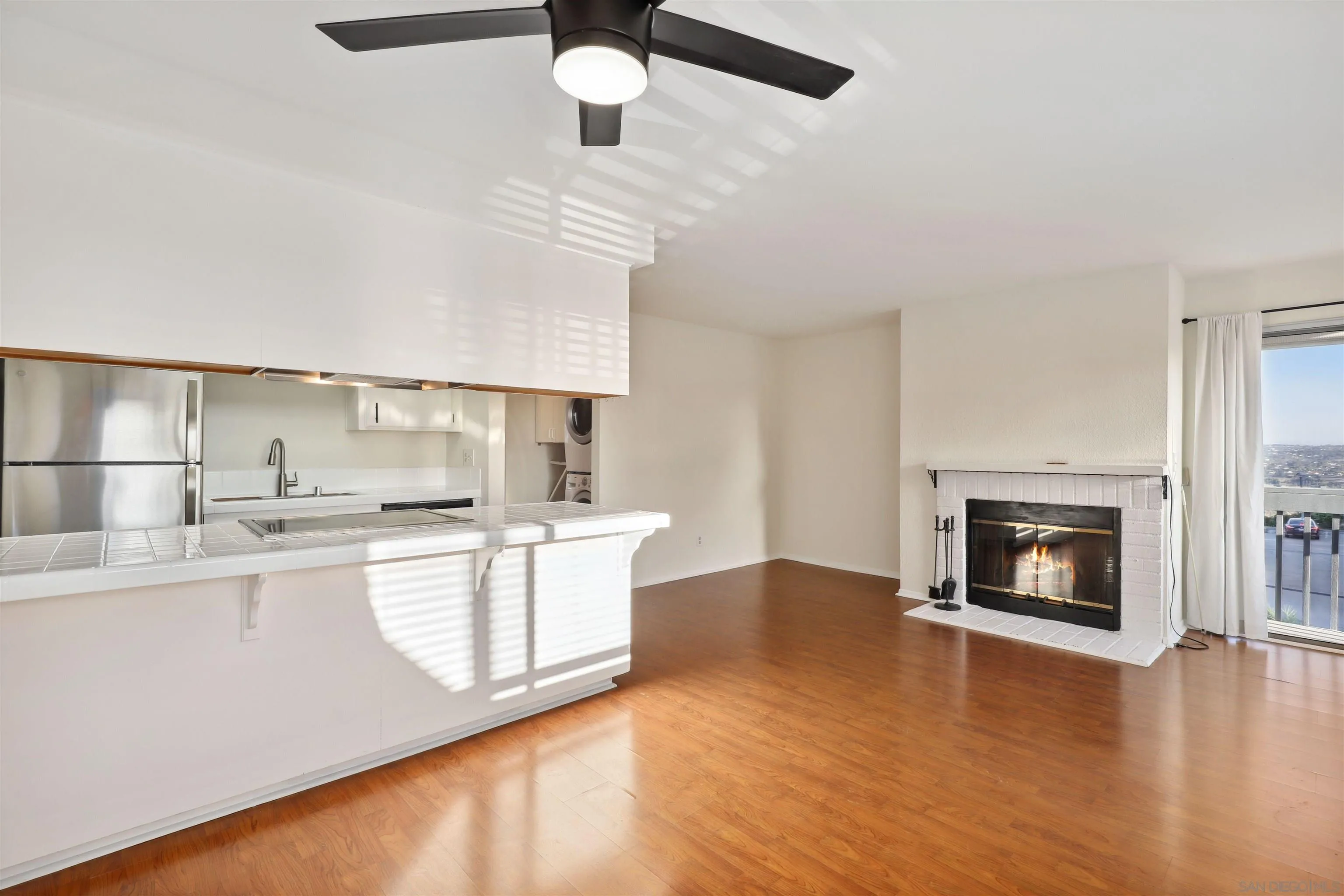 8475 Avenida Angulia, Unit 4 Spring Valley, CA 91977 - Photo 4 of 25 a kitchen with stainless steel appliances granite countertop a stove top oven a sink with a dining table and chairs