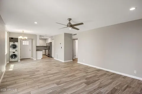 a view of an empty room with a kitchen