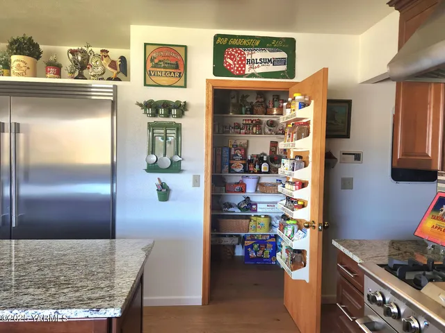 a kitchen with lots of clutter and cabinets